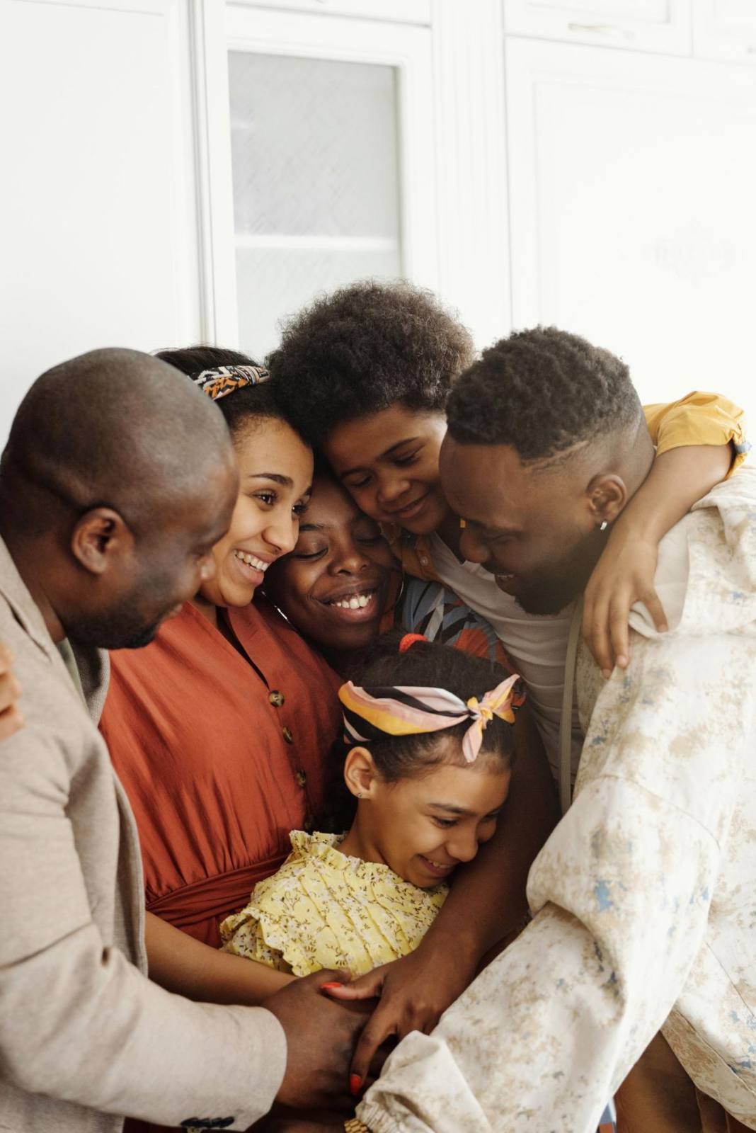 A family holding each other close in a warm embrace