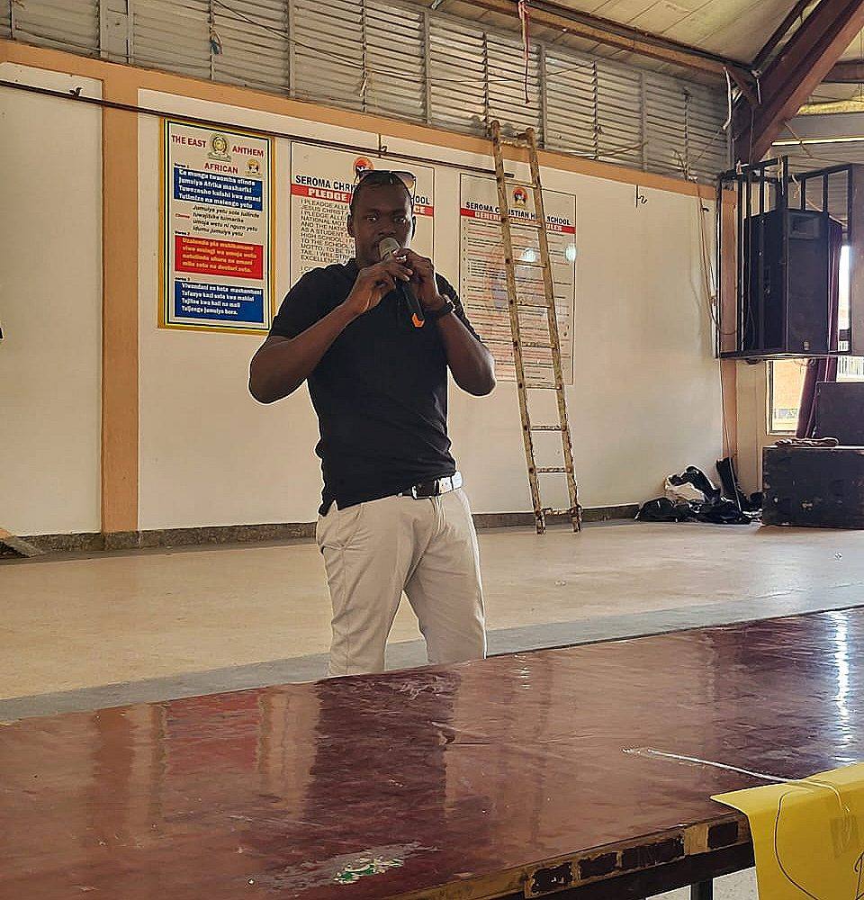 A Voices of Recovery speaker talking to students with a microphone