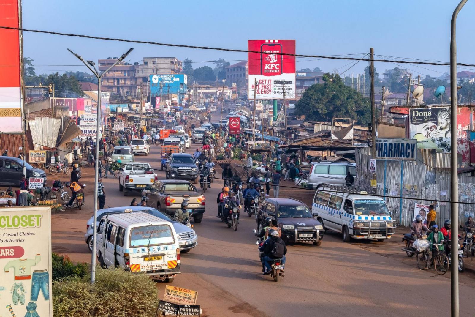A busy street in Kampala with boda bodas and traffic